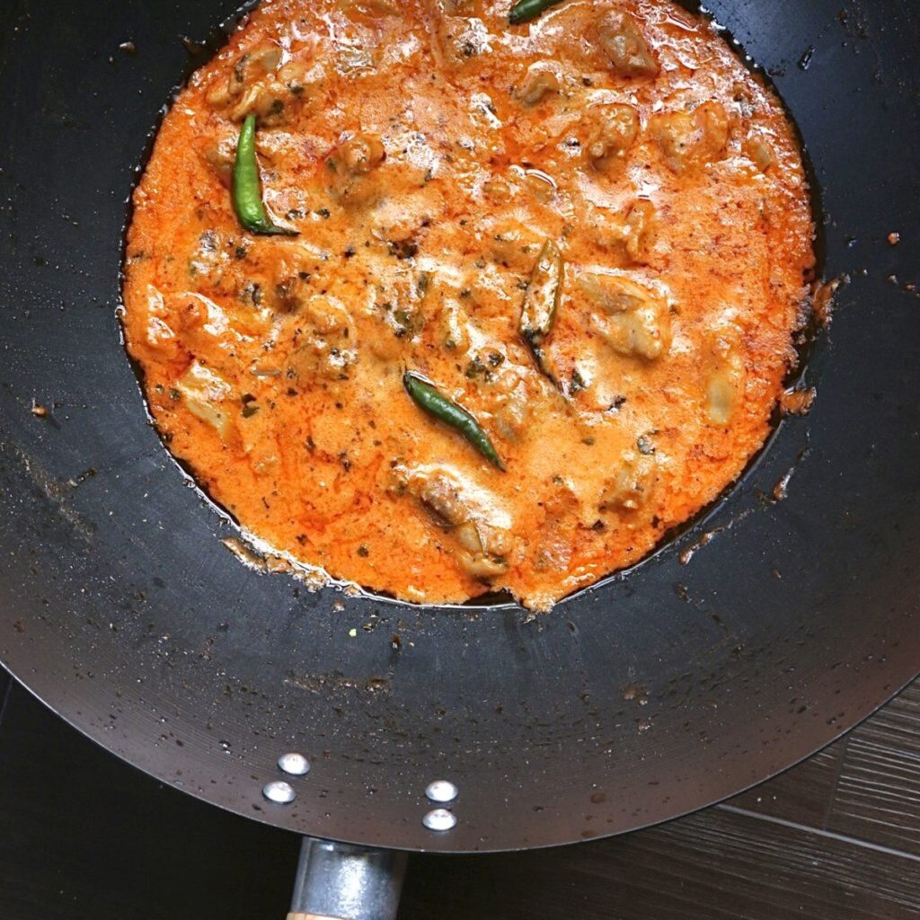 A wok of Pakistani makhni chicken in a creamy tomato gravy 